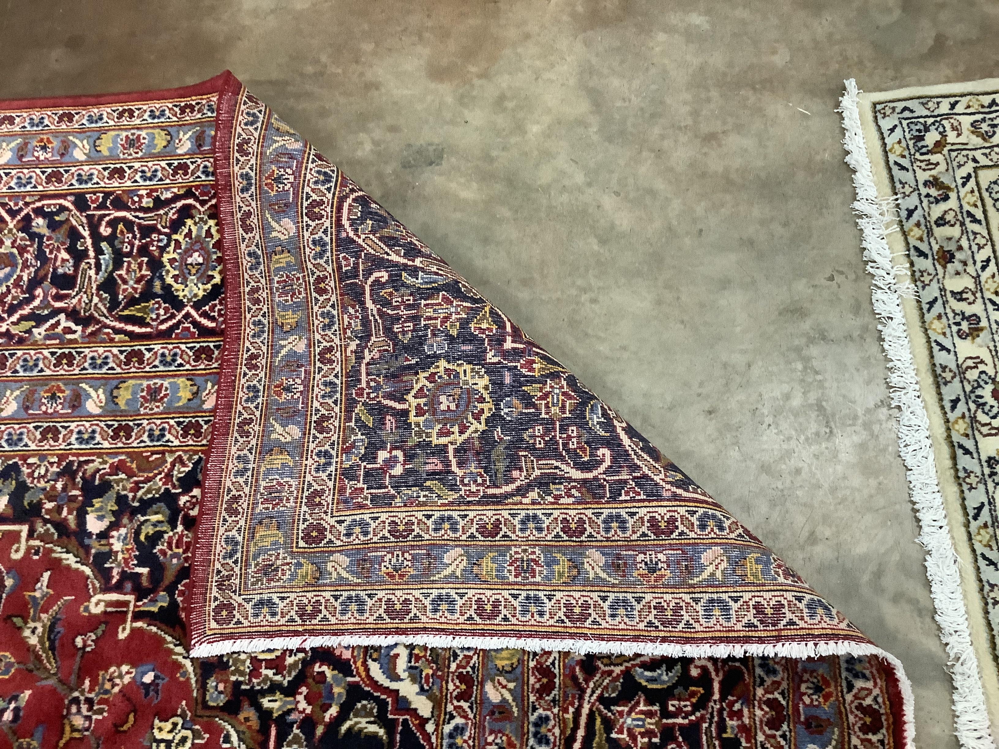 A Kashan red ground carpet, 355 x 240cm